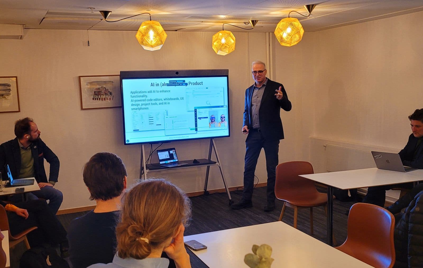 Amir Elion talking with a small group in a workshop room